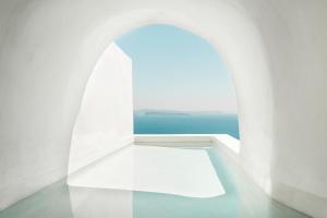 a white room with a view of the ocean at Armenaki in Oia