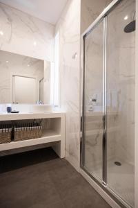 a bathroom with a glass shower and a sink at MyTrip Porto in Matosinhos +37 photos
