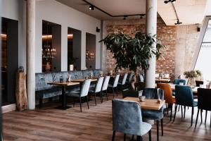 a restaurant with tables and chairs and a brick wall at My Place in Lautzenhausen