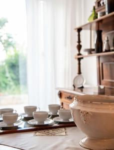 a table with a bunch of bowls and cups on it at Silva Apartments in Alberobello