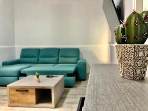 a living room with a blue couch and a coffee table at CASA VACANZA RESILIENZA in Marsala