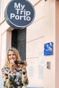 a woman standing in front of a my trip porto sign at MyTrip Porto in Matosinhos