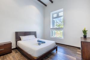 a bedroom with a bed with a dresser and a window at Royal Apartments City Centre Willemstad in Willemstad
