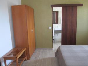 a bedroom with a bed and a cabinet and a sink at Baleal à Vista in Baleal