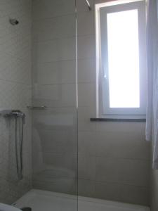 a shower with a glass door in a bathroom at Baleal à Vista in Baleal