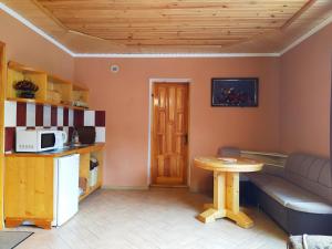 a living room with a table and a couch at Guest House Shafran in Yaremche
