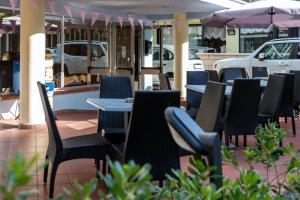 a group of chairs and tables on a patio at My Hotel Cesenatico in Cesenatico