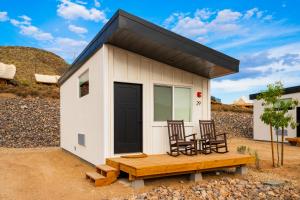 a tiny house with two chairs and a table at Zion Wildflower in Virgin
