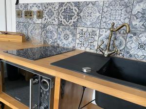 a kitchen counter with a sink and a microwave at Queen Street Boutique Suites in Edinburgh