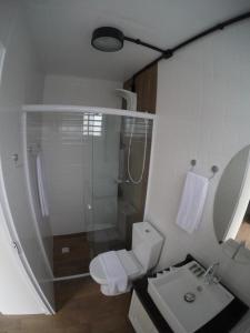 a bathroom with a shower and a toilet and a sink at Vila Container in Penha