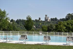 a swimming pool with chairs and a fence at Agriturismo Gian Galeazzo Visconti in Valeggio sul Mincio