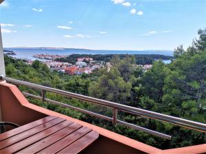 a balcony with a wooden bench and a view at Apartments Lumar in Palit