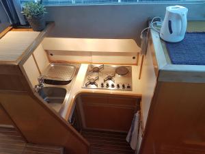 a small kitchen with a stove and a sink at BOAT APPART TITANIC Cherbourg motor yacht à quai ROSE STAR in Cherbourg en Cotentin +28 photos