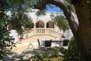 a table and chairs in front of a house at Agriturismo Salinola in Ostuni