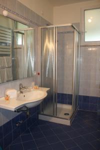 a bathroom with a sink and a shower at Residence Miralago Rooms & Apartments in Manerba del Garda