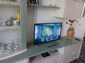 a television sitting on a shelf in a room at Sun and Sea House 3 Rooms & Wifi in Arinaga