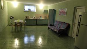 a living room with a couch and a table at Дом на Одесской ул. in Chornomorsk