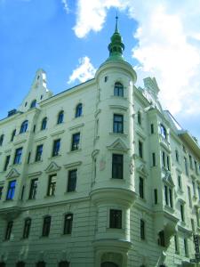 a white building with a tower on top of it at Hotel-Pension Wild in Vienna