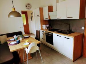 a kitchen with a wooden table and a kitchen with a sink at Family Home Weißensee in Greifenburg