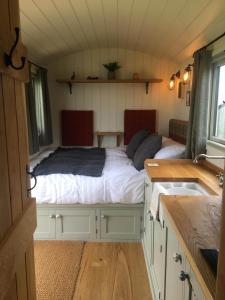 a bedroom with a bed in a tiny house at 40 Bernisdale - Shepherds Hut in Skeabost