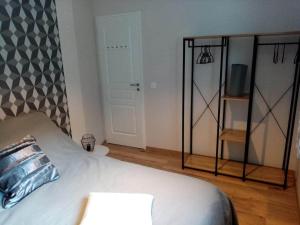 a bedroom with a bed with a pillow and a mirror at L' Aubisque in Eaux-Bonnes