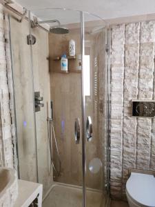 a shower with a glass door in a bathroom at B&B Casa Dilillo in Foggia