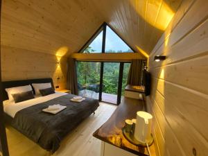 a bedroom with a bed and a large window at Villa Alpiyka in Slavske