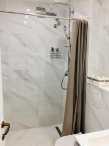 a shower with a glass door in a bathroom at Apartments Juraković in Živogošće