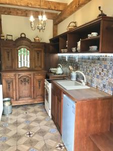 a kitchen with wooden cabinets and a sink at Apartmány ReMi Vysoké Tatry in Smokovce