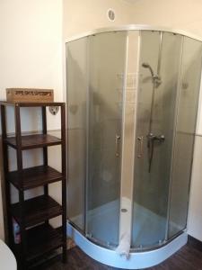 a shower with a glass enclosure in a bathroom at Mazurskidom Zapiecek in Świętajno