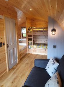 a living room with a blue couch in a cabin at Ben Loyal Hotel in Tongue +140 photos