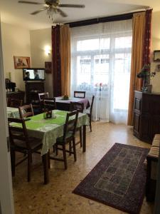 a dining room with a table and chairs and a window at B&B Amelia in Pescara