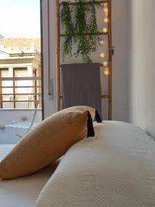 a bed with a pillow sitting on top of it at Hostal Sol in Zamora +36 photos