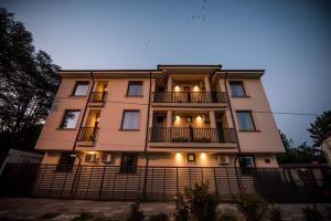 a tall building with lights on the front of it at Casa 1A in Eforie Sud