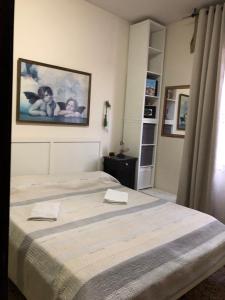 a bedroom with two beds and a picture on the wall at B&B Amelia in Pescara