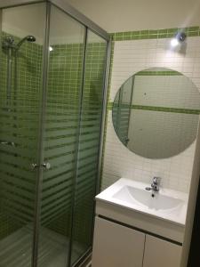 a bathroom with a shower and a sink and a mirror at La Capital del Jerte in Plasencia +24 photos