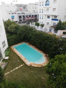 an overhead view of a swimming pool in a yard with buildings at Costa Marina 212 in Hammamet