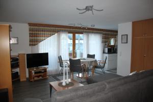 a living room with a couch and a table at Moutain View in Laax