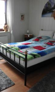 a large bed in a bedroom with a bedspread on it at Wikingerstadt 1 in Schleswig