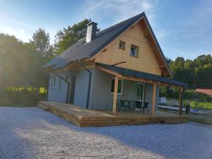 a small house with a porch and a deck at Domek Bobrowe Zacisze 2 in Karpacz +9 photos