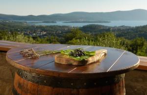 a table with a cutting board on top of a barrel at Sunset Holiday Home in Tivat
