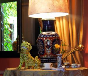 a vase sitting on a table next to a lamp at Casa Misha in San Miguel de Allende