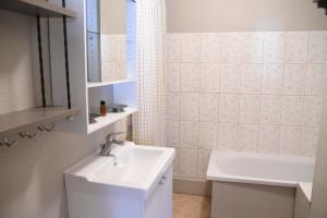 a white bathroom with a sink and a mirror at Superbe appartement Font Romeu La Pardallera in Font Romeu Odeillo Via +40 photos
