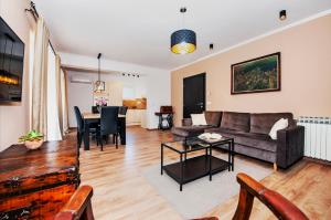 a living room with a couch and a table at Apartment Miral in Rovinjsko Selo
