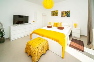 a white bedroom with a bed and a tv at Apartment Veroeva in Rukavac