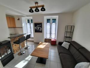 a living room with a couch and a table at Appartement Port de St Goustan in Auray