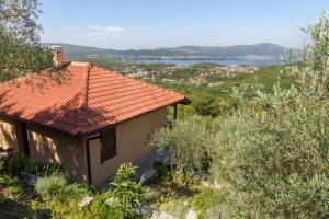 a house with a red roof on a hill at Sunset Holiday Home in Tivat