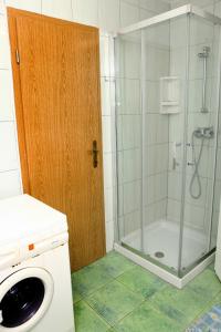 een badkamer met een douche met een glazen deur bij Apartmaji ORKO s pogledom na morje - Sea View Apartments ORKO in Portorož
