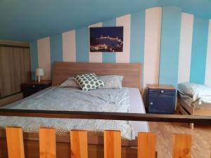 Schlafzimmer mit einem Bett mit blauen und weißen Streifen in der Unterkunft Apartament na Rynku in Chęciny