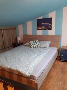 a bedroom with a large bed with a wooden headboard at Apartament na Rynku in Chęciny